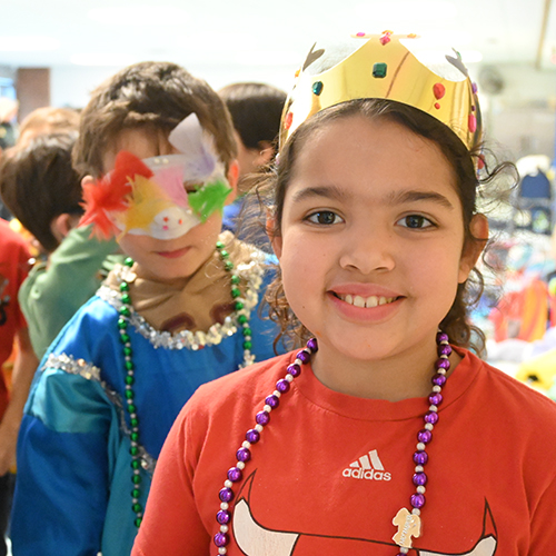 After school enrichment photo of children in costumes for Mardi Gras
