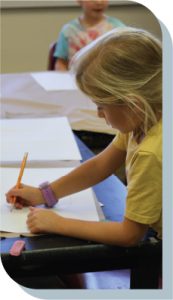 Photo of young girl drawing on paper