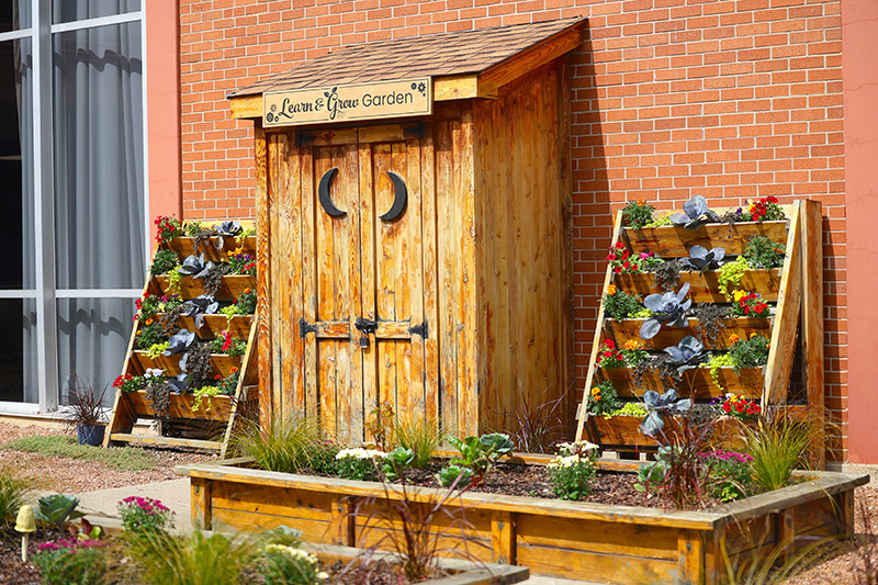 The Learn & Grow Garden in early fall displaying its new sign